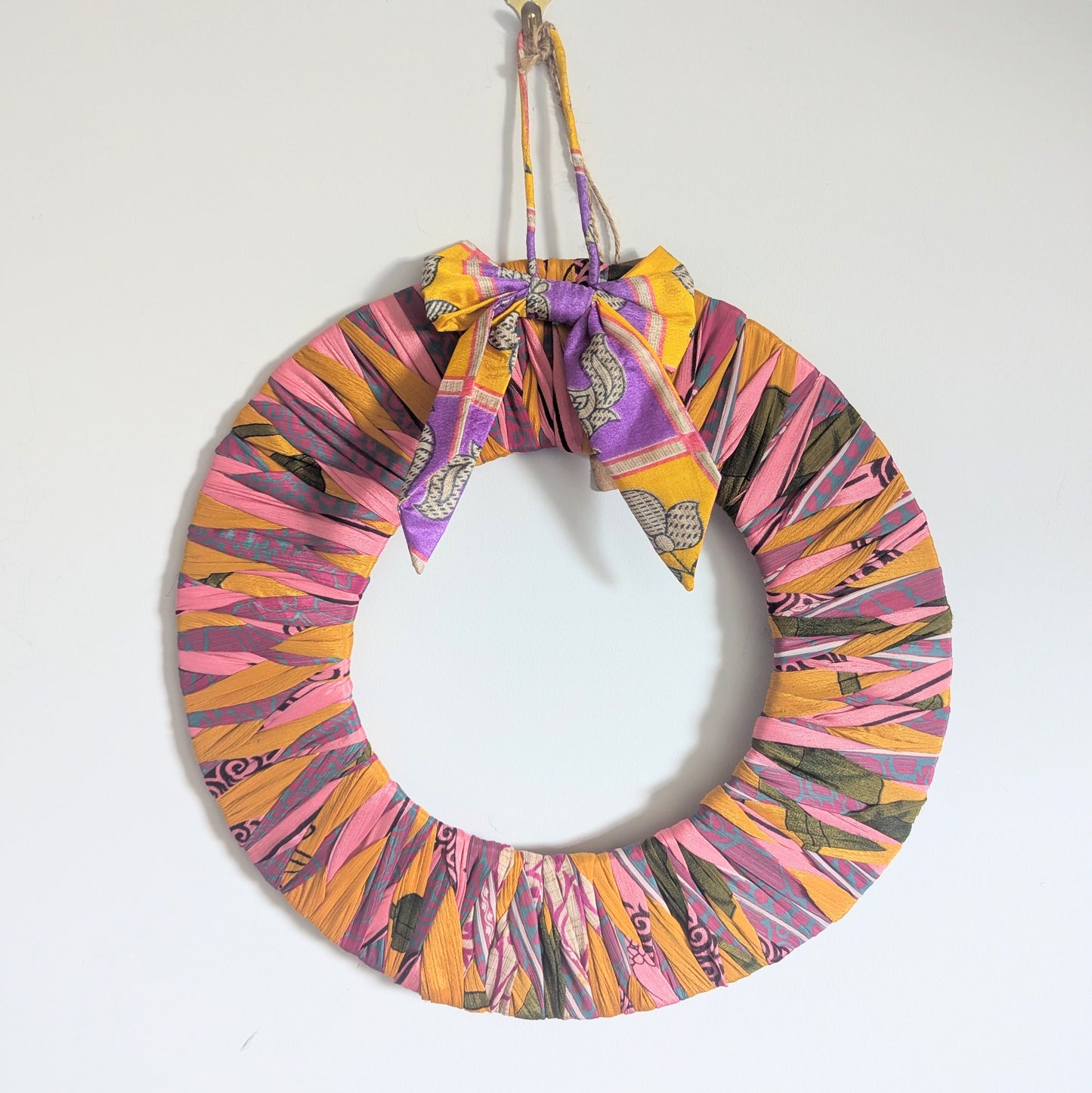 Colorful wreath with a bow on a white background