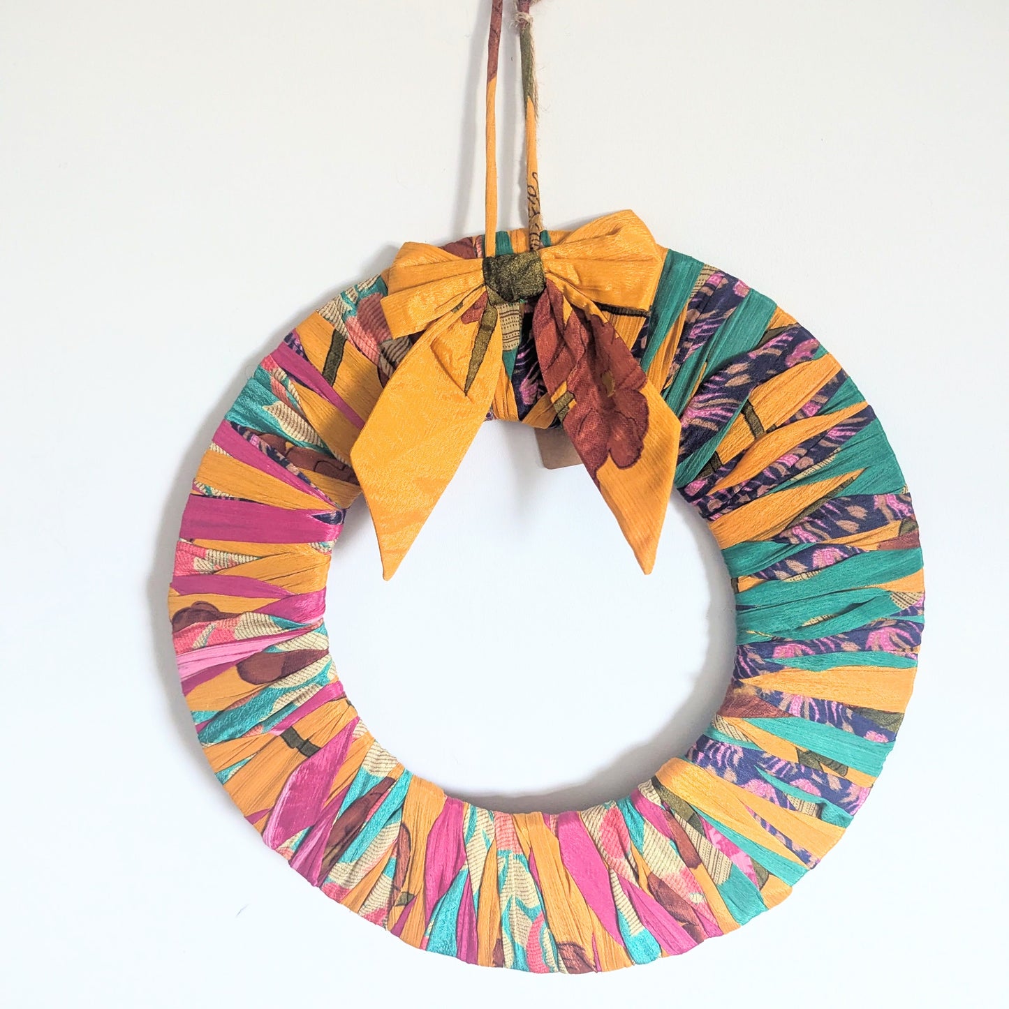 Colorful wreath with a yellow bow on a white background
