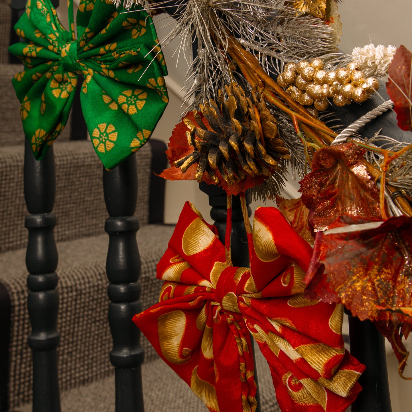 Decorative wreath with colorful bows on a staircase railing.
