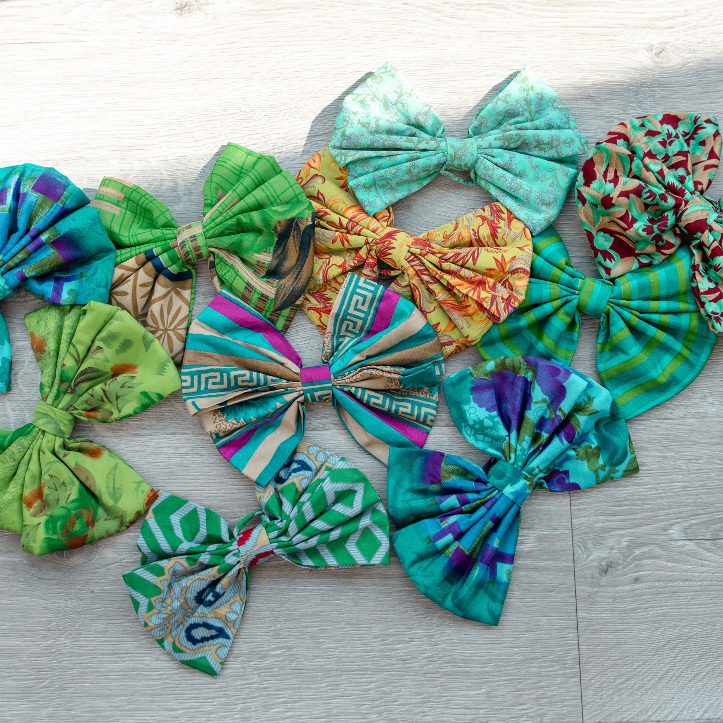Colorful fabric green bows on a wooden surface