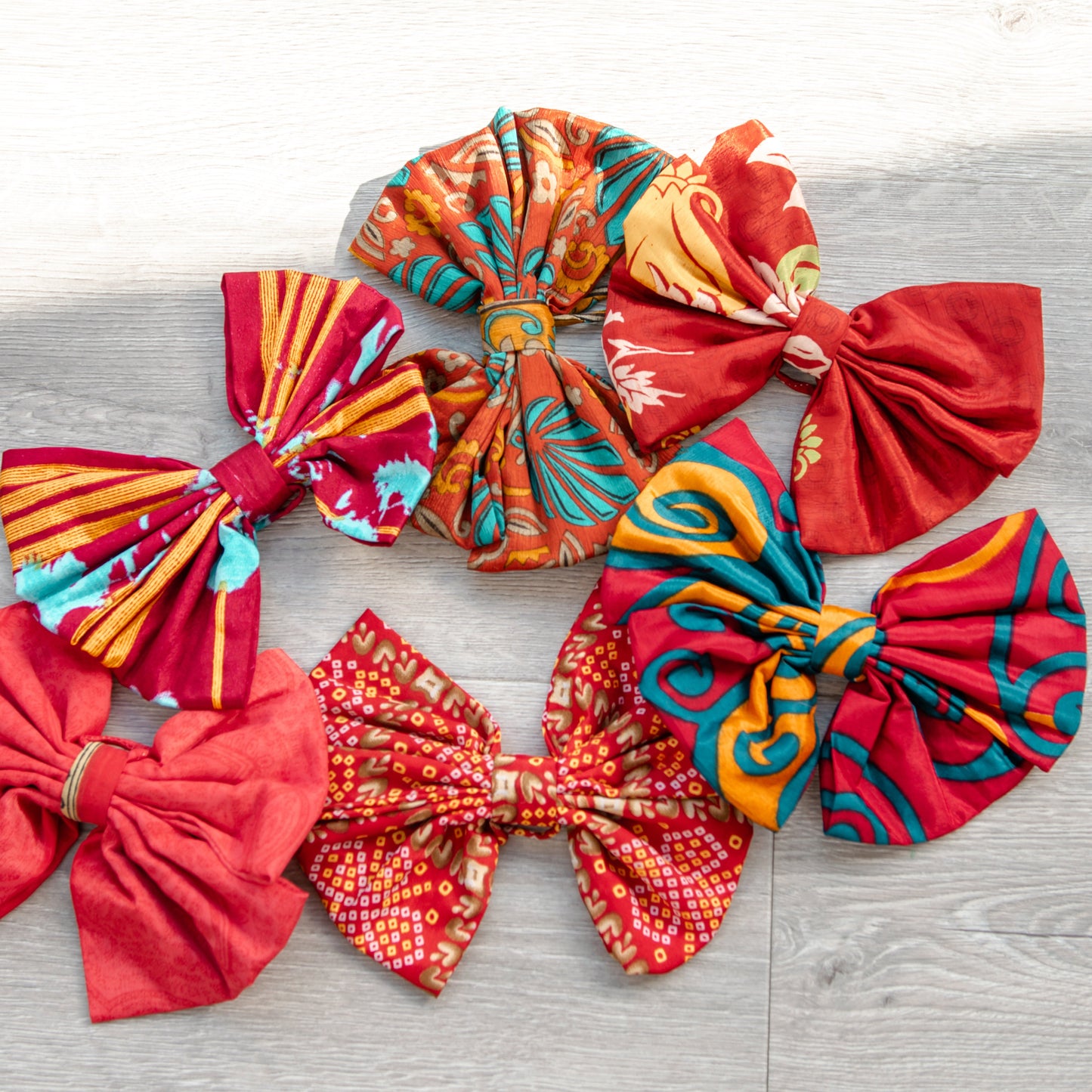 Colorful fabric bows on a wooden surface