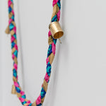 Colorful braided cord with gold cap on a white background
