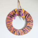 Colorful wreath with a bow on a white background