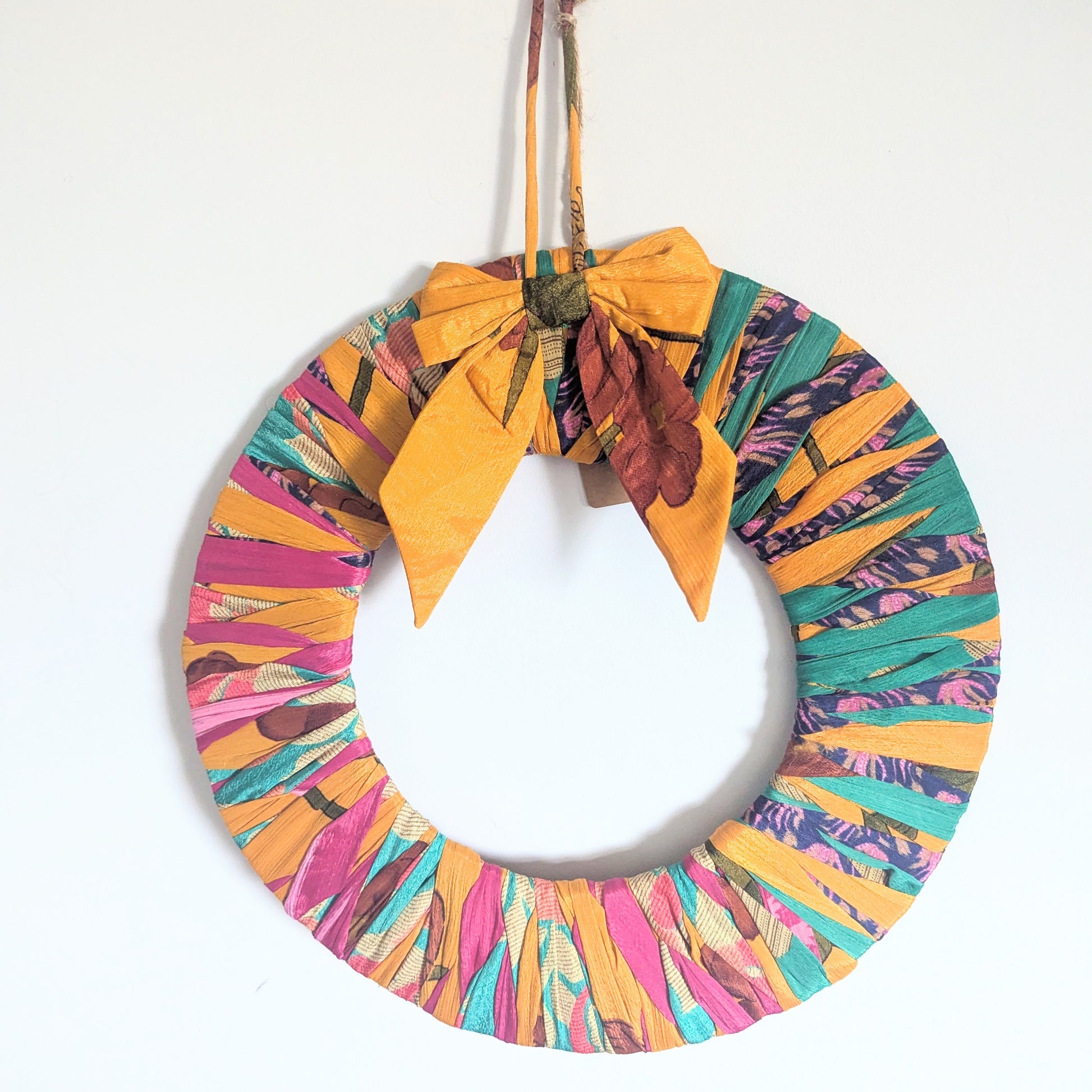 Colorful wreath with a yellow bow on a white background