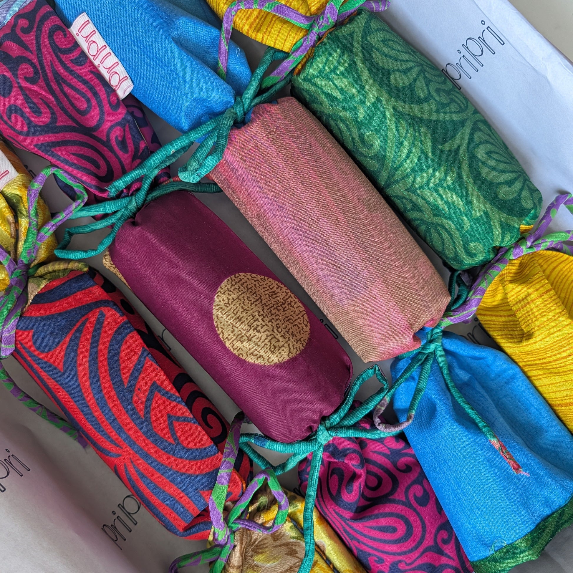 Colorful fabric-wrapped products with patterns on a white surface