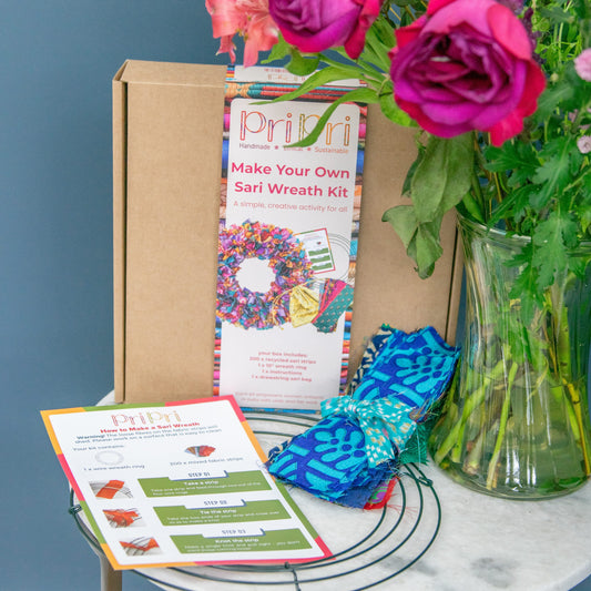 Make Your Own Sari Wreath Kit with materials on a table against a blue wall