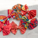 Colorful fabric bows on a wooden surface