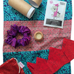 Collection of products and accessories on a patterned fabric background