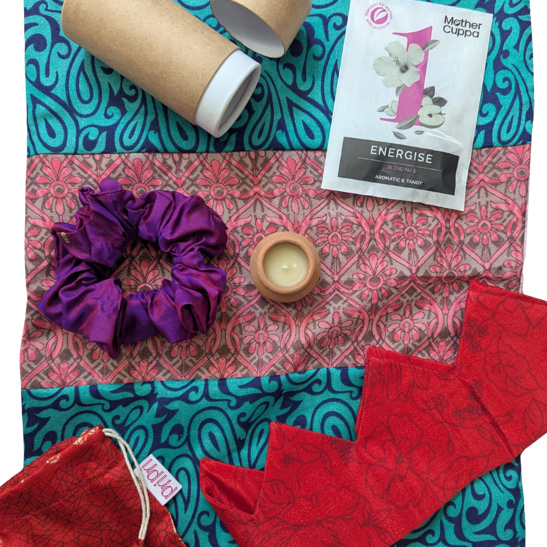 Collection of products and accessories on a patterned fabric background