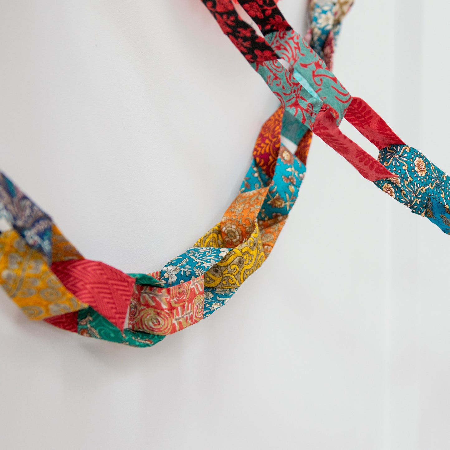 Colorful fabric chain on a white background