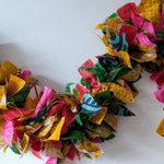 Colorful fabric wreath on a white background