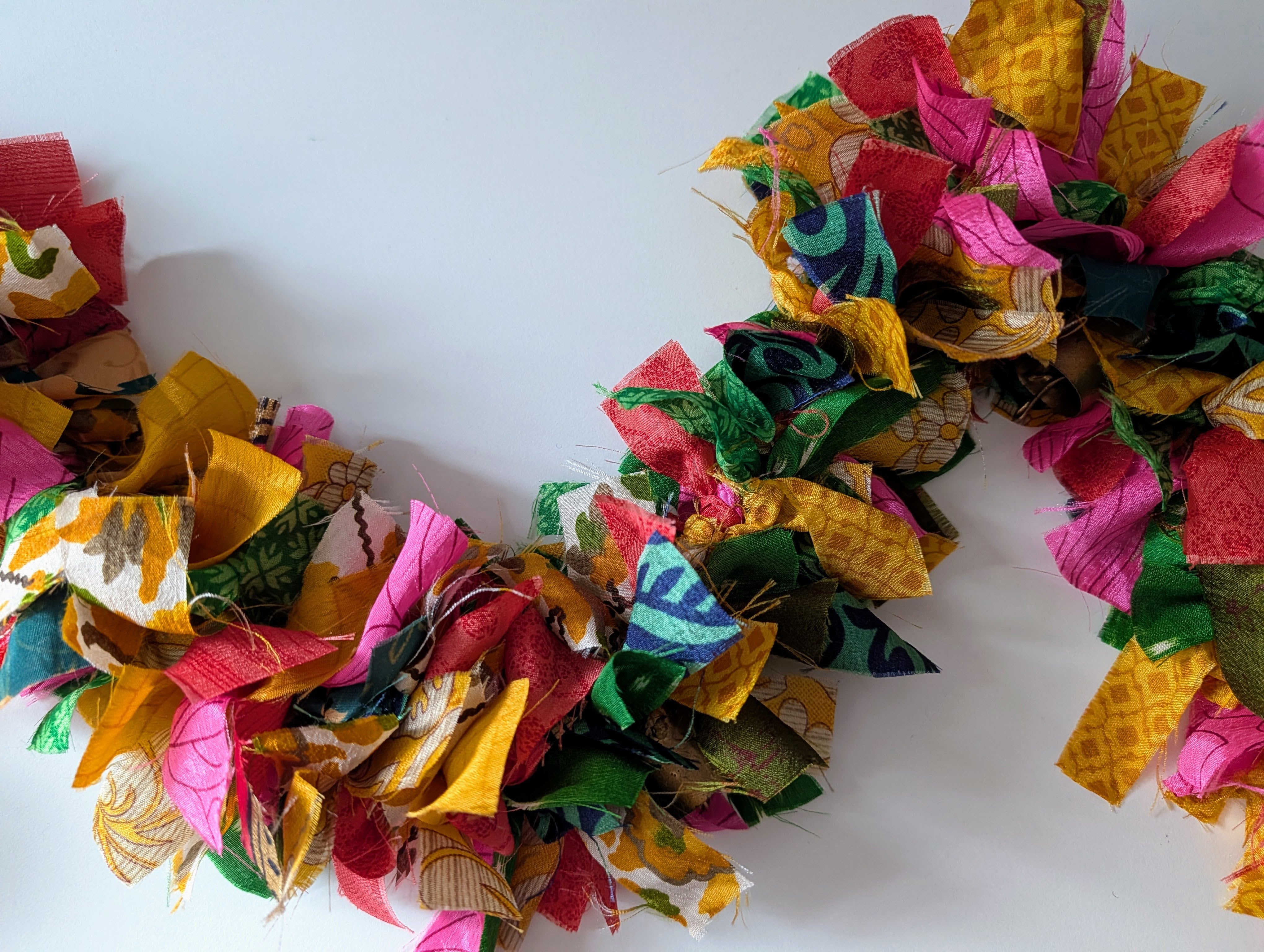 Colorful fabric wreath on a white background