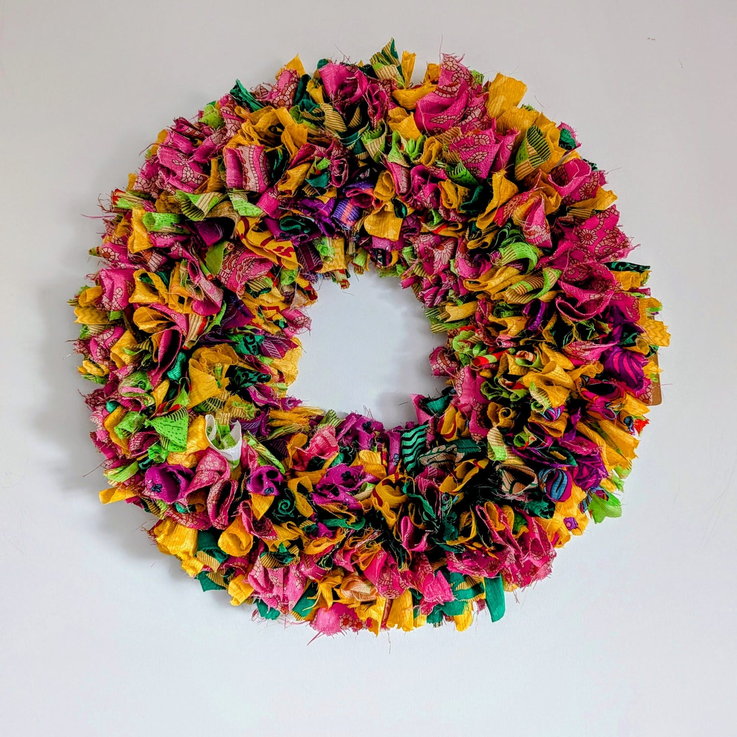 Colorful fabric wreath on a white background