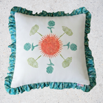 Decorative pillow with a sun and leaf design on a textured surface