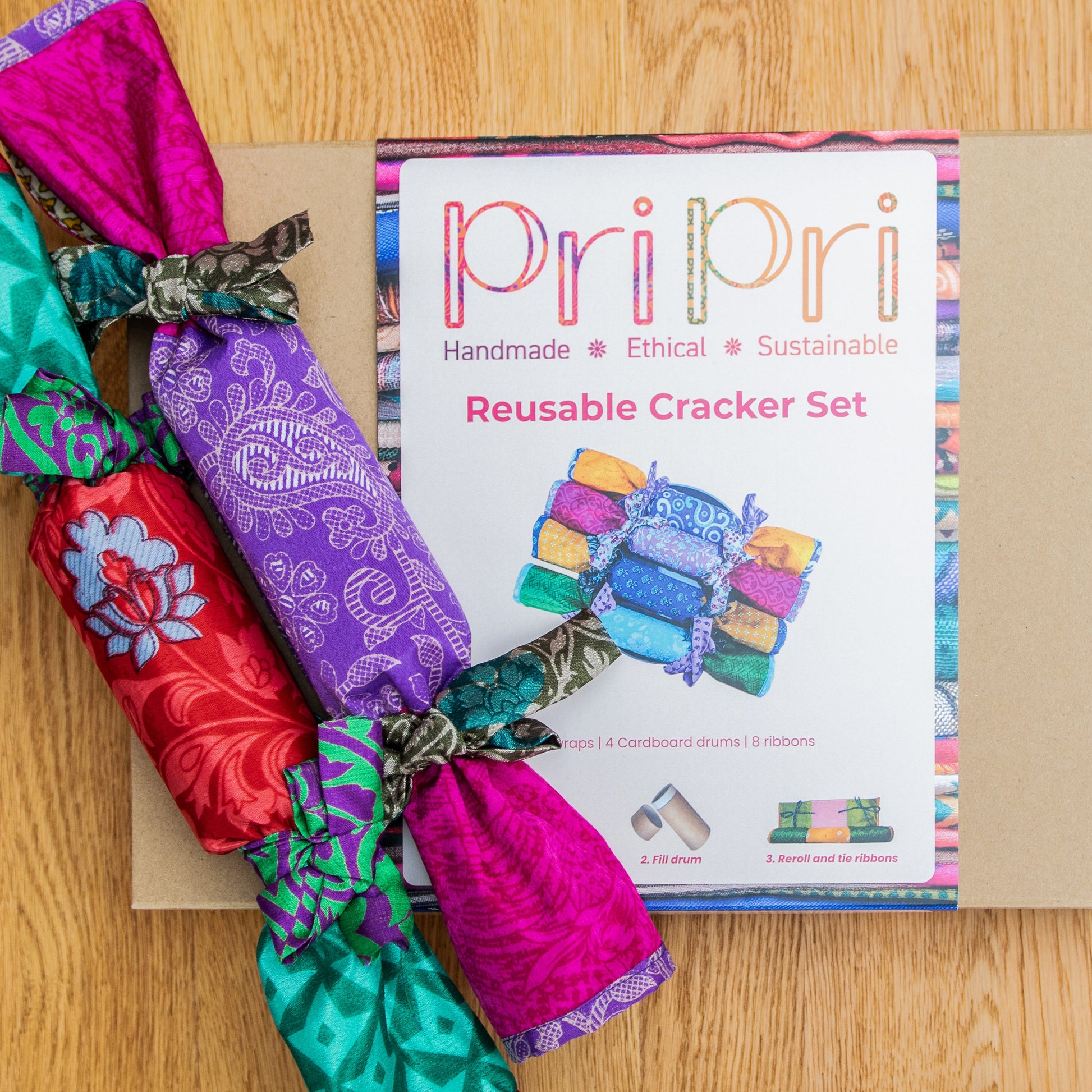 Colourful reusable cracker set with packaging on a wooden surface