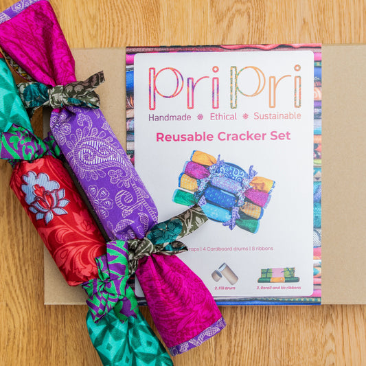 Colourful reusable cracker set with packaging on a wooden surface